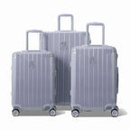 Trois valises rigides GYL Intemporelle argent, format cabine et soute, avec poignée trolley déployée.  #couleur_argent