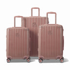 Trois valises rigides GYL Intemporelle rose gold, format cabine et soute, avec poignée trolley déployée.  #couleur_rose gold