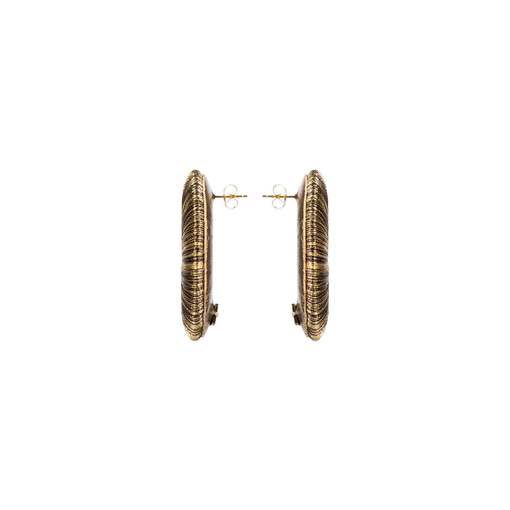 Close-up view of Boho Gold Earring showcasing intricate hand-wrapped metallic threads in circular design.
