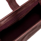 Close-up of a burgundy in a shade of dark cherry leather with a same tone interior and card slots