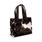 Dark brown and cream cow print pattern tote bag with dark brown rope handles on a white background. When the inner straps are joined, the bag takes on a more rounded shape.