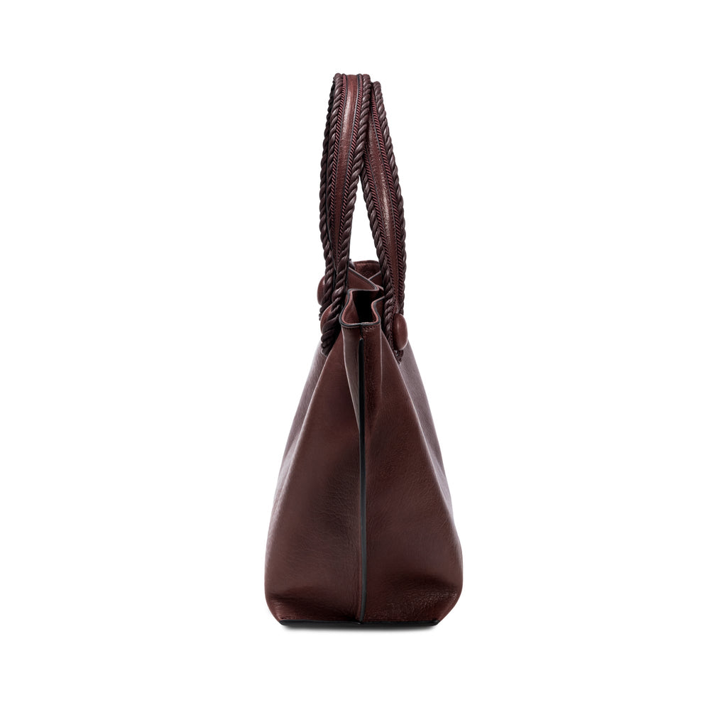 Burgundy leather in a shade of dark cherry tote bag with rope handles on a white background, shown from the side.