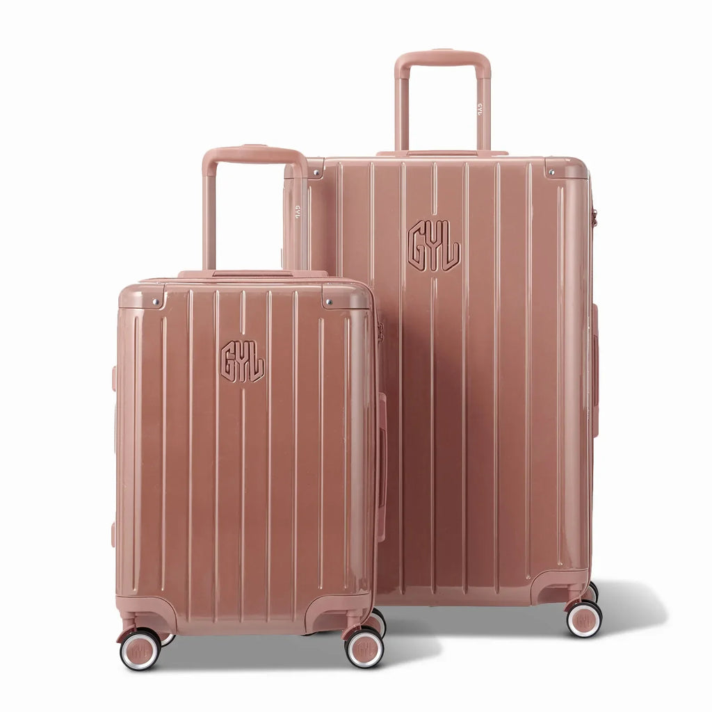 Deux valises rigides GYL Intemporelle rose gold, format cabine et soute, avec poignée trolley déployée. #couleur_rose gold
