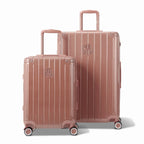 Deux valises rigides GYL Intemporelle rose gold, format cabine et soute, avec poignée trolley déployée. #couleur_rose gold