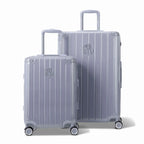 Deux valises rigides GYL Intemporelle argent, format cabine et soute, avec poignée trolley déployée. #couleur_argent
