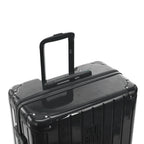 Poignée trolley télescopique GYL déployée sur la valise Intemporelle gris foncé en polycarbonate. #couleur_gris foncé