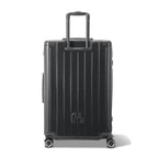 Vue arrière de la valise rigide GYL Intemporelle gris foncé avec poignées intégrées et roulettes pivotantes. #couleur_gris foncé
