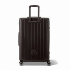 Vue arrière de la valise rigide GYL Intemporelle noir avec poignées intégrées et roulettes pivotantes. #couleur_noir