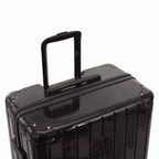 Poignée trolley télescopique GYL déployée sur la valise Intemporelle noir en polycarbonate. #couleur_noir