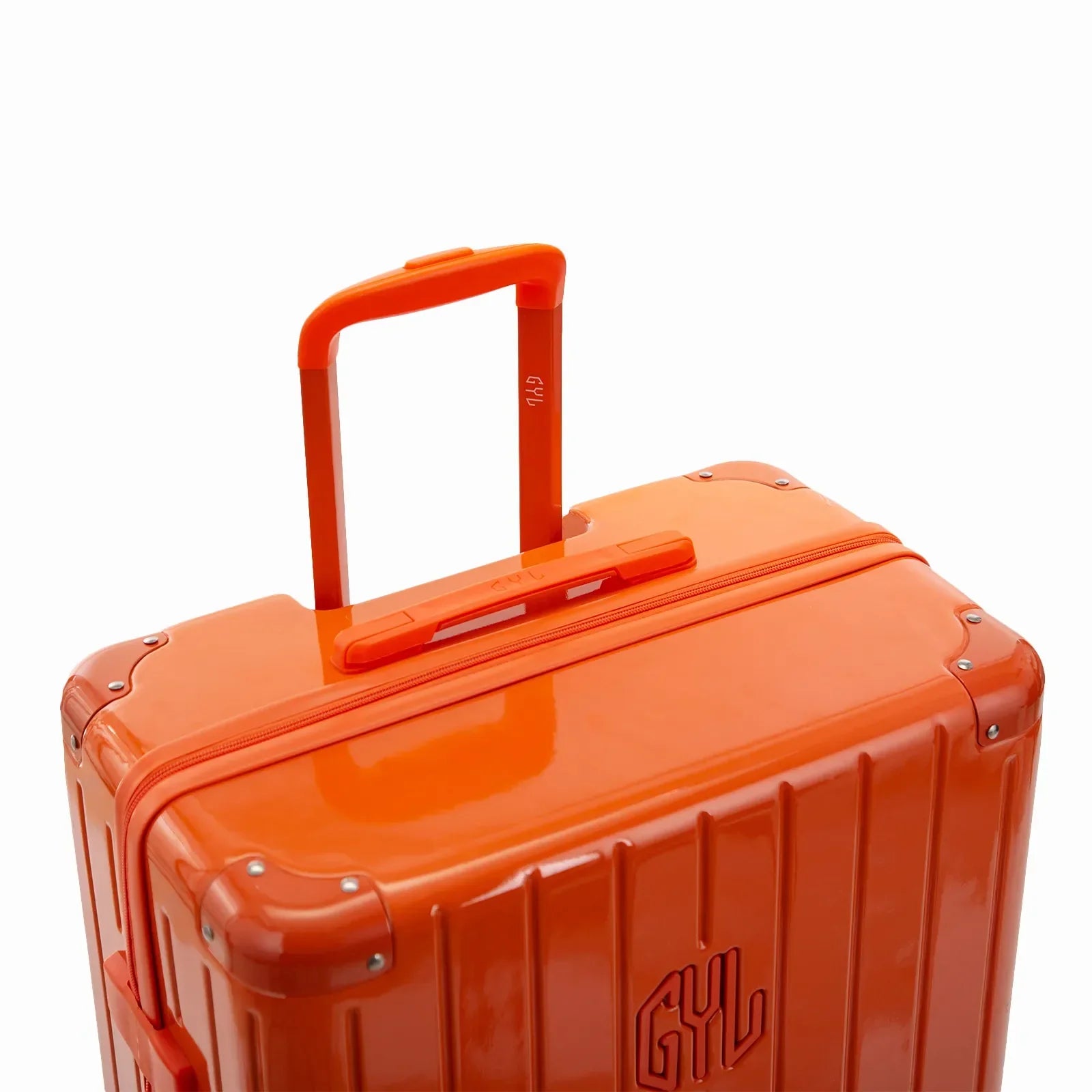Poignée trolley télescopique GYL déployée sur la valise Intemporelle orange en polycarbonate. #couleur_orange foncé