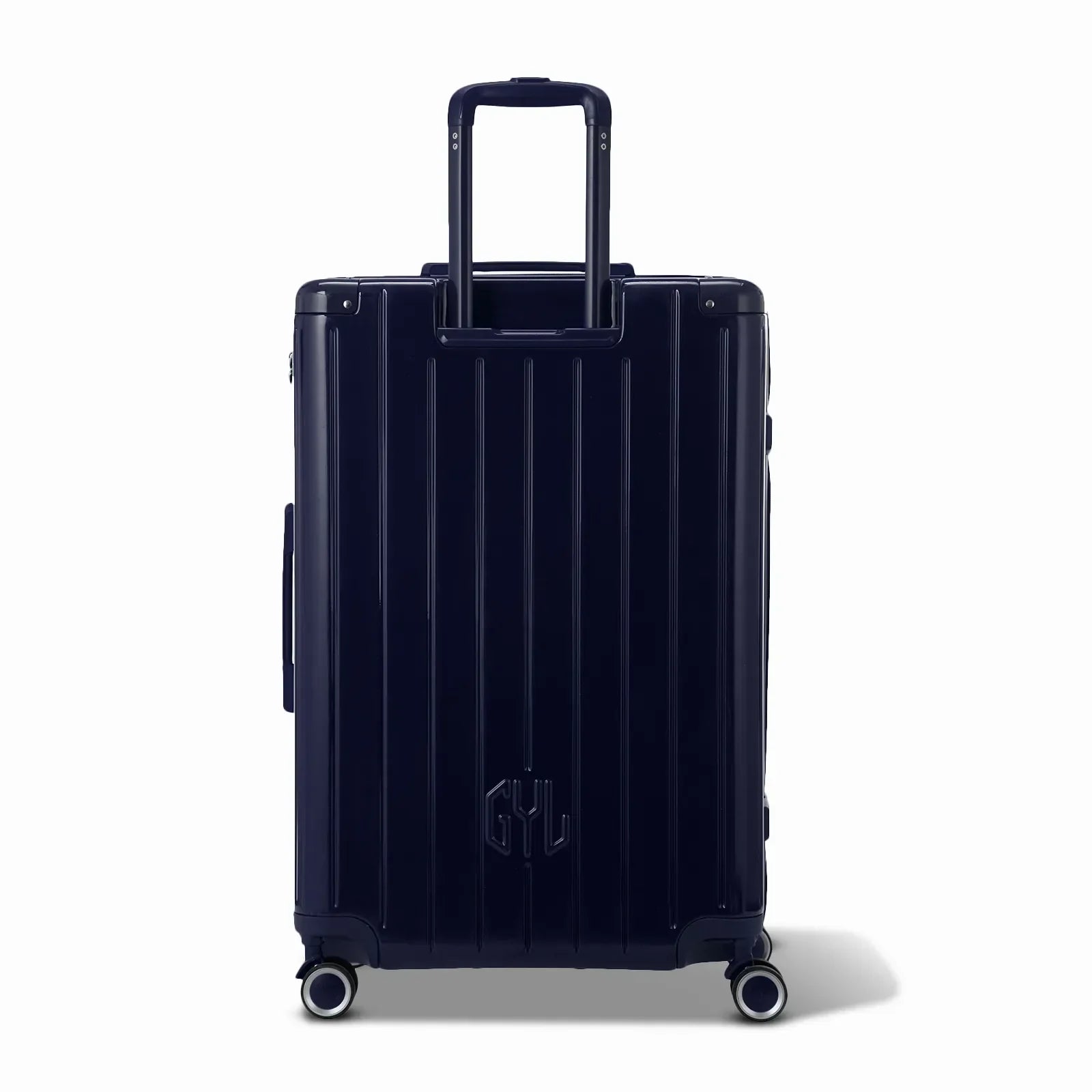 Vue arrière de la valise rigide GYL Intemporelle marine avec poignées intégrées et roulettes pivotantes. #couleur_marine