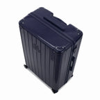 Vue en angle de la valise rigide GYL Intemporelle marine avec coins renforcés et coque nervurée brillante. #couleur_marine