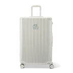 Vue avant de la valise rigide GYL Intemporelle sable, logo embossé et roulettes 360 degrés. #couleur_sable