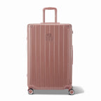 Vue avant de la valise rigide GYL Intemporelle rose gold, logo embossé et roulettes 360 degrés. #couleur_rose gold