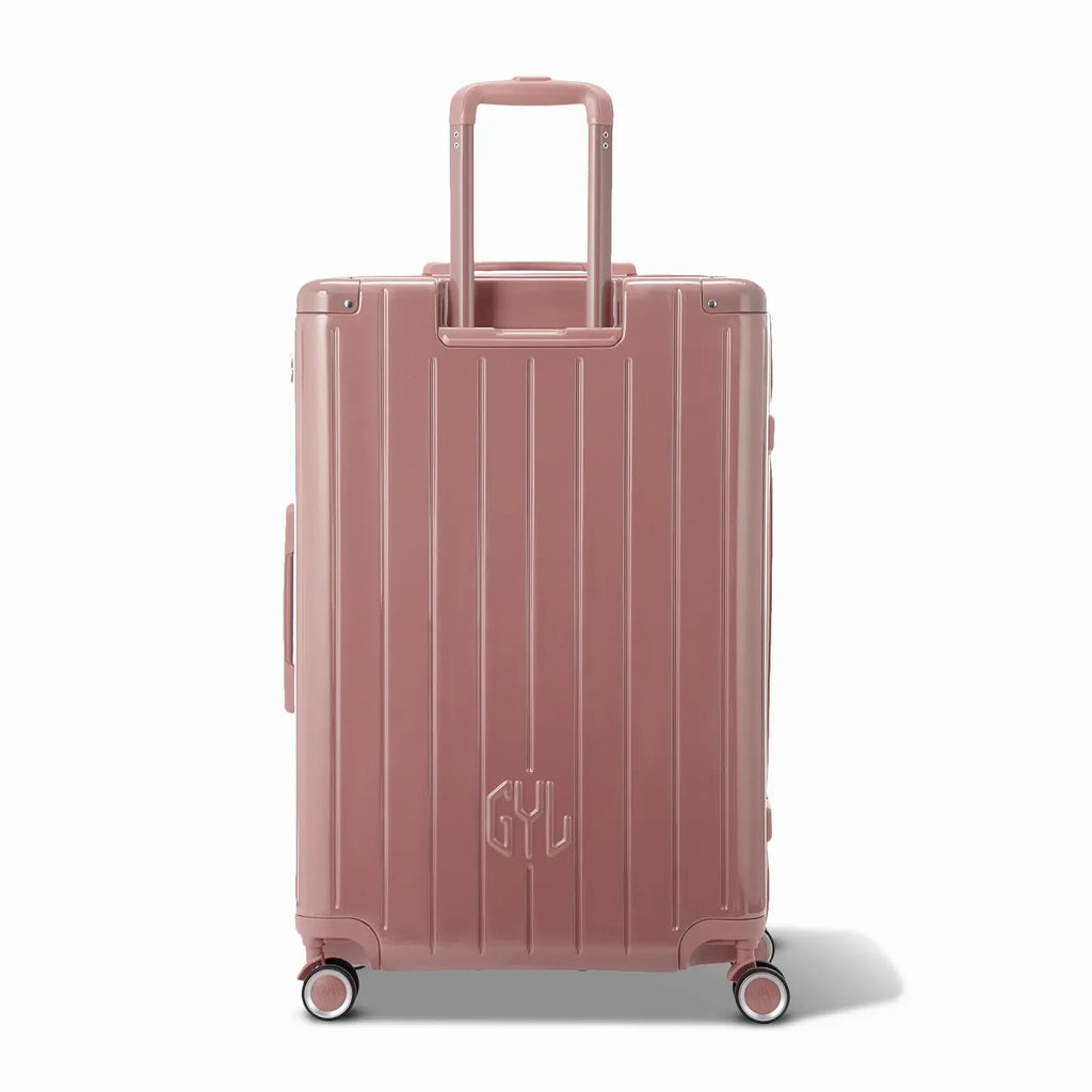 Vue arrière de la valise rigide GYL Intemporelle rose gold avec poignées intégrées et roulettes pivotantes. #couleur_rose gold