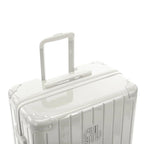Poignée trolley télescopique GYL déployée sur la valise Intemporelle sable en polycarbonate. #couleur_sable