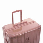 Poignée trolley télescopique GYL déployée sur la valise Intemporelle rose gold en polycarbonate. #couleur_rose gold