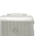 Poignée supérieure rigide de la valise GYL Intemporelle sable avec logo embossé sur le dessus. #couleur_sable