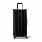 Valise trunk GYL taille XL en polycarbonate noir vue de face, avec trolley déployé et roues 360°.  #couleur_noir