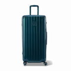 Valise trunk GYL taille XL en polycarbonate sapin vue de face, avec trolley déployé et roues 360°.  #couleur_sapin