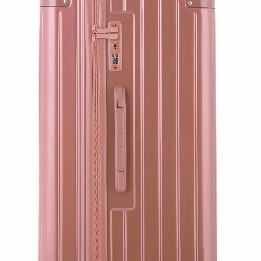 Détail de la serrure TSA et de la poignée latérale sur la valise trunk rose gold. #couleur_rose gold