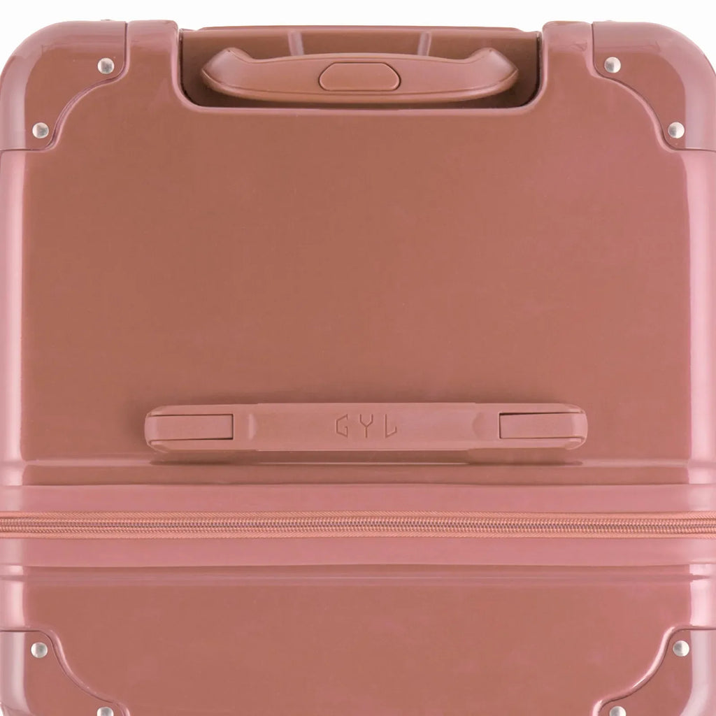 Vue du dessus de la valise trunk GYL rose gold en polycarbonate, avec poignée centrale et coins renforcés. #couleur_rose gold