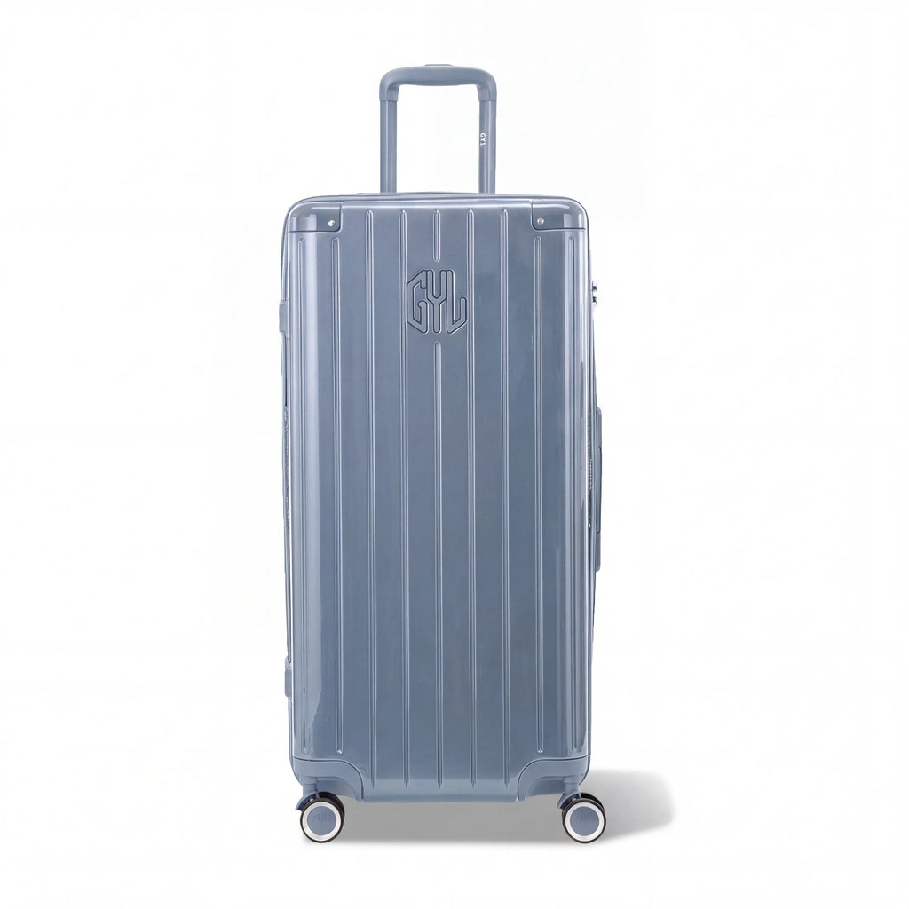 Valise trunk GYL taille XL en polycarbonate bleu gris vue de face, avec trolley déployé et roues 360°.  #couleur_bleu grisé