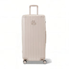 Valise trunk GYL taille XL en polycarbonate nude vue de face, avec trolley déployé et roues 360°.  #couleur_nude
