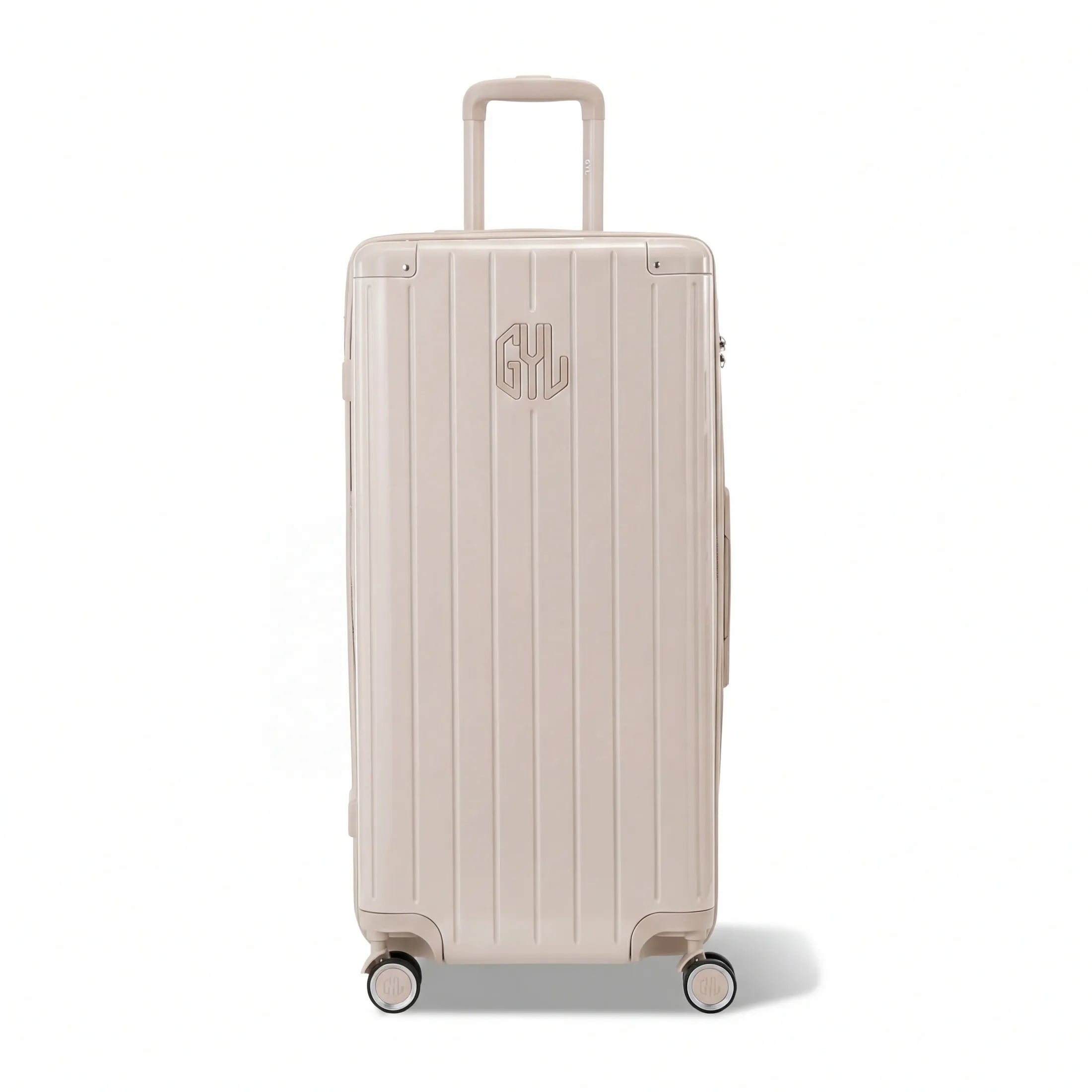 Valise trunk GYL taille XL en polycarbonate nude vue de face, avec trolley déployé et roues 360°.  #couleur_nude