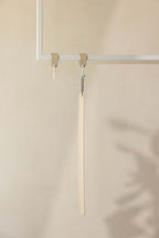 Schuhlöffel TILO aus hochwertigem Metall an einem minimalistischen Haken in modernem Interieur.