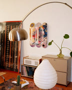 Living room with decorative elements including a lamp, vase, and a skate triptych by Wassily Kandinsky.