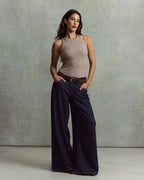 Jean large en denim bleu foncé, coupe fluide et confortable, matière robuste avec une finition lisse adaptée à toutes les morphologies féminines.