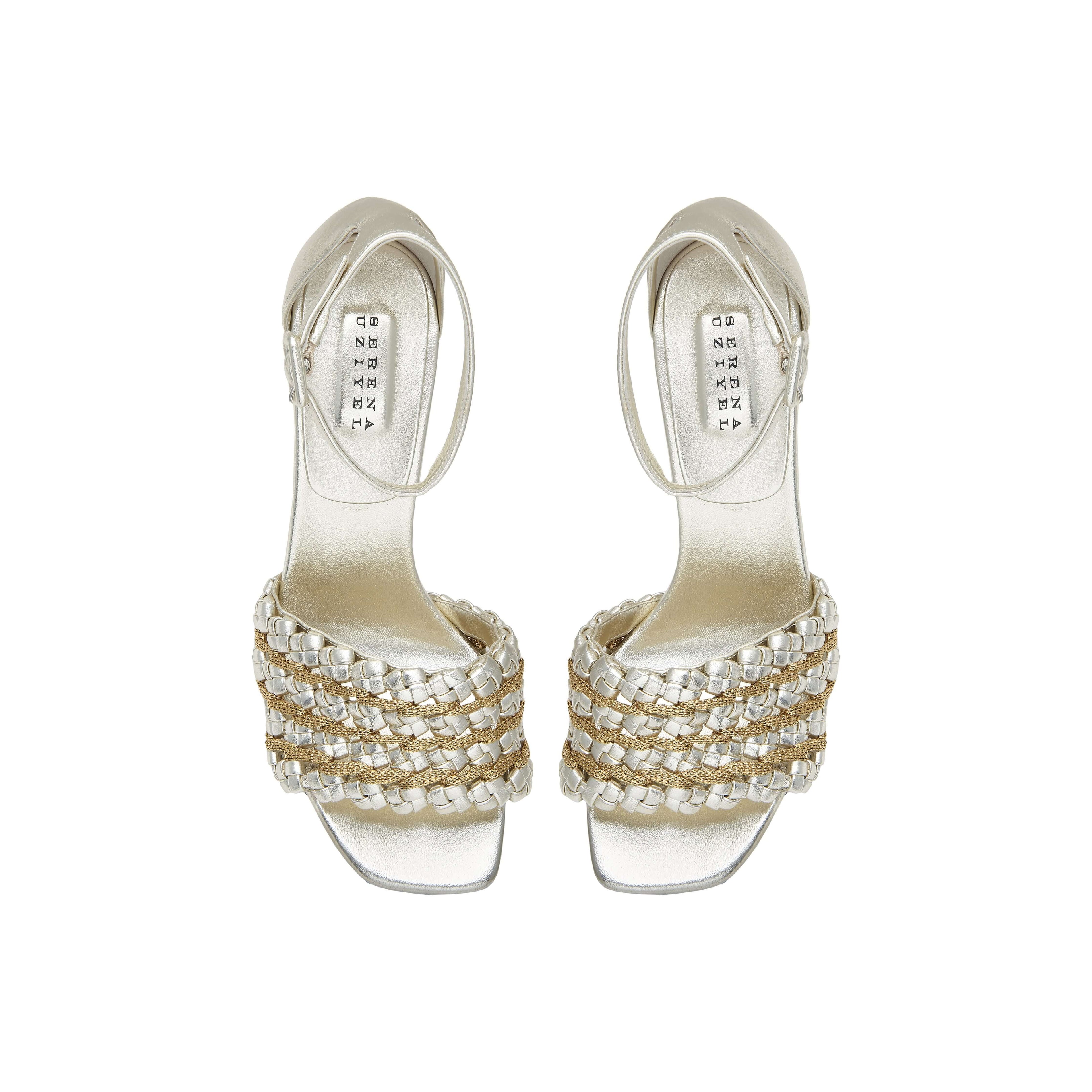 Elegant silver high-heeled sandals with unique braided design and ankle strap, perfect for formal occasions.