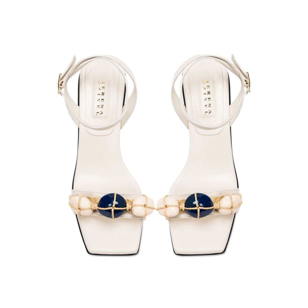 Delphine 50MM Ankle Cross Sandal in ivory with aqua beads and wide straps, blending nature-inspired colors.