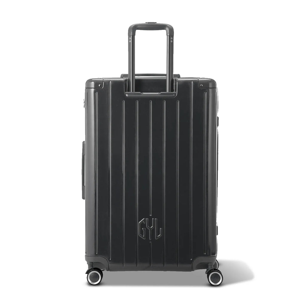 Vue arrière de la valise rigide GYL Intemporelle noir avec poignées intégrées et roulettes pivotantes. #couleur_gris foncé