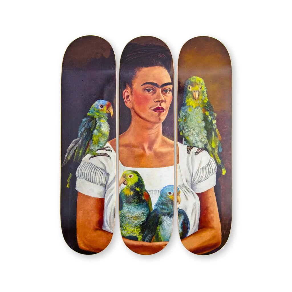 Frida Kahlo's 'Me and My Parrot' artwork reimagined on a triptych skateboard deck set by THE SKATEROOM. Featuring Kahlo’s self-portrait with vibrant parrots, this open edition celebrates her iconic artistry and bold expression.