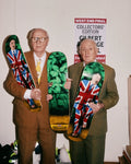 Gilbert & George holding their "The Nettle Dance" skateboard triptych by THE SKATEROOM in their London Studio.