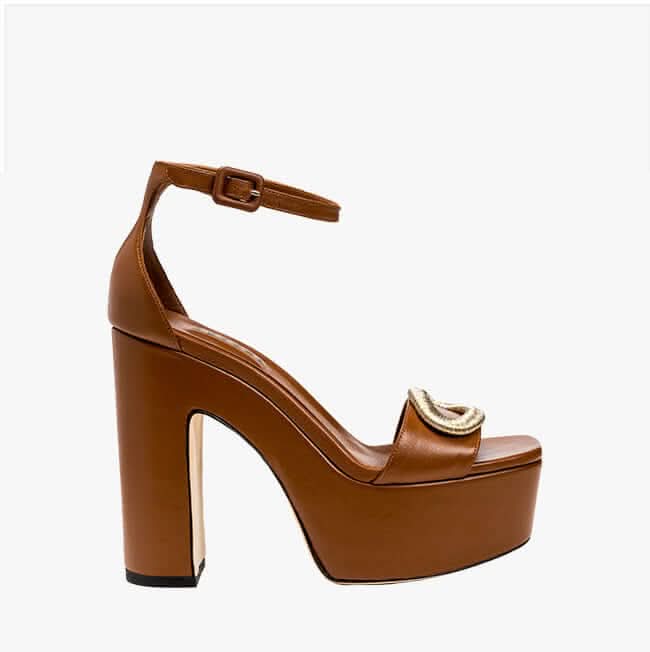 Naria Camello tan platform ankle sandal featuring a bold oval embellishment and molded footbed, elegantly crafted in Italy.