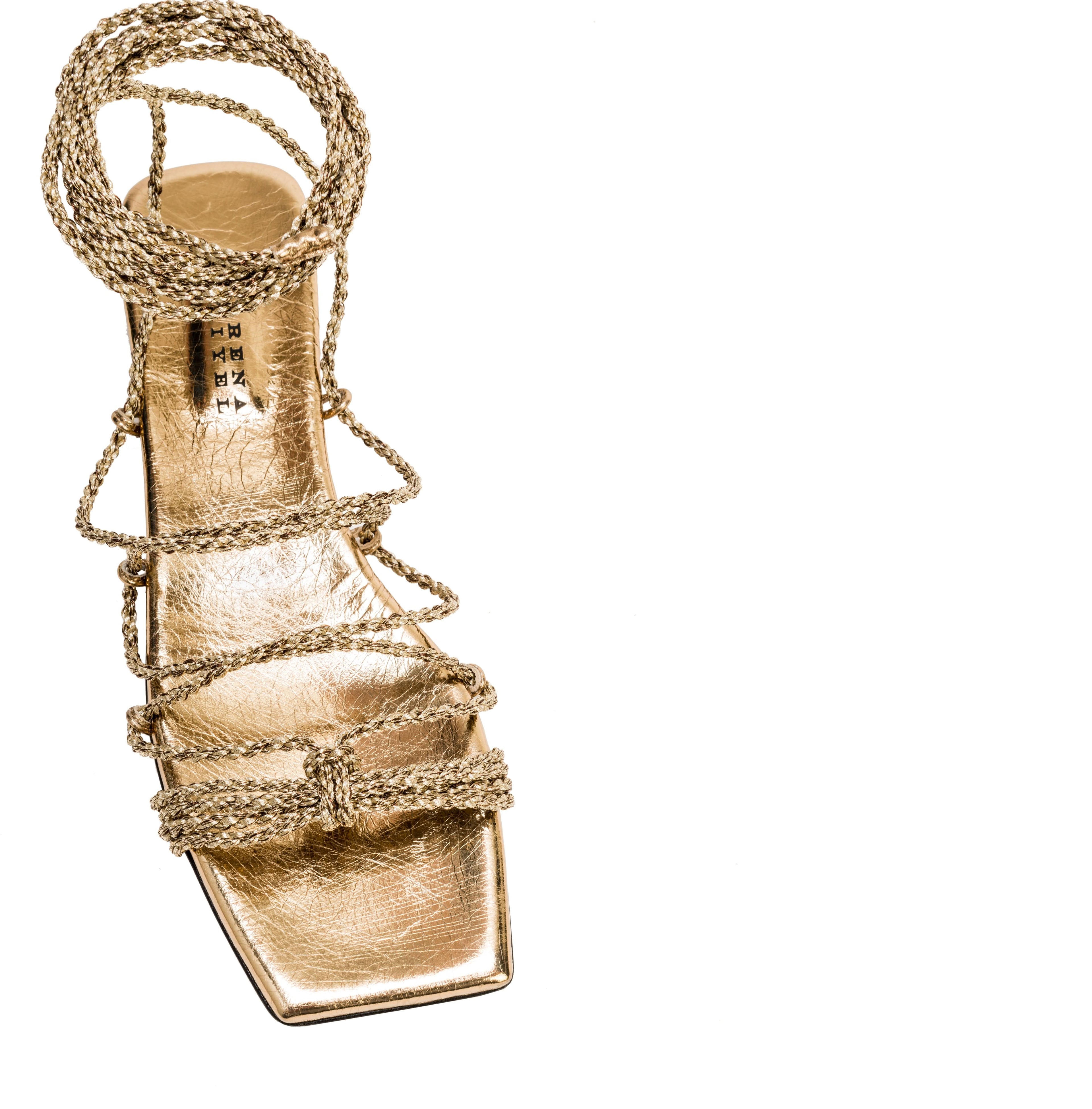 Ophilia Gold Flat Lace-Up Sandal in antique gold with braided straps, ideal for elegant and trendy occasions.