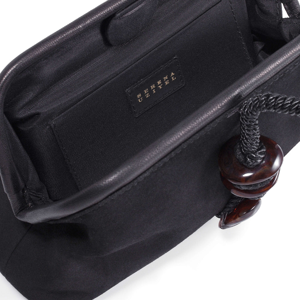 Inside view of the Petra Black Pouch Bag, featuring a suede leather interior and stylish detail.