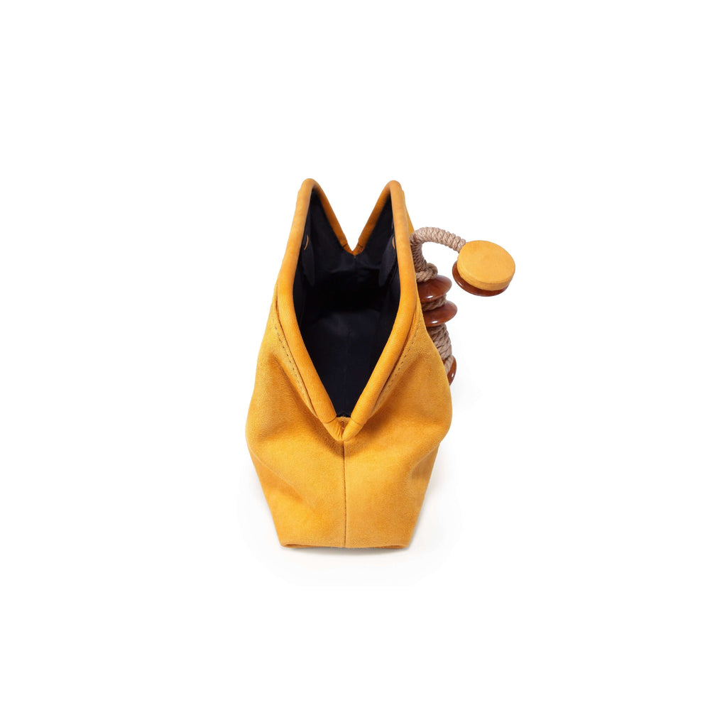 Petra Mustard Pouch Bag featuring a unique design with a drawstring closure and a stylish mustard color.