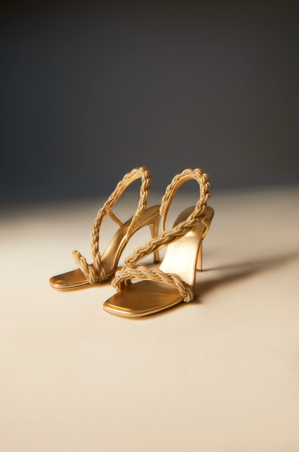Roxana gold high-heel asymmetric sandals featuring antique gold embroidery and slender 90 mm heels.
