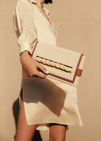 Thory Camello Envelope Clutch in natural canvas with camello leather trim, featuring a twisted raffia closure.