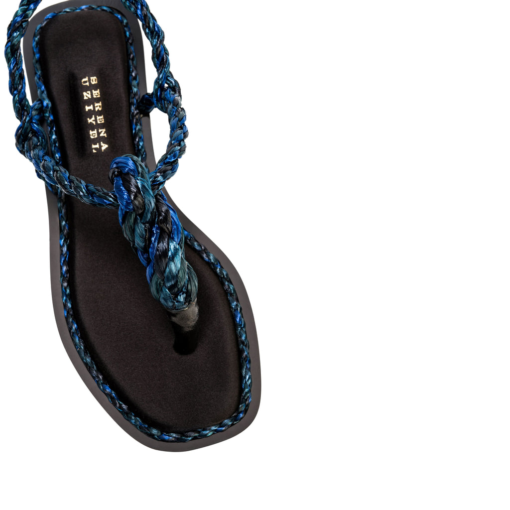 Thory Navy Flat Sandal featuring elegant braided navy raffia straps and a minimalist silk satin design.