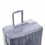 Poignée trolley télescopique GYL déployée sur la valise Intemporelle argent en polycarbonate. #couleur_argent