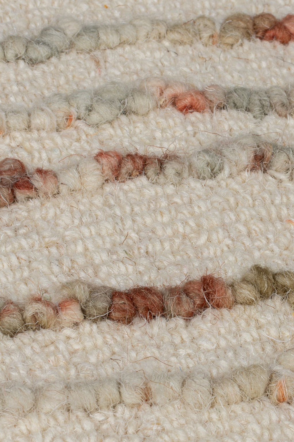 zoom sur la matière et son tissage du tapis swirl coloris orange et naturel#couleur_naturel-orange